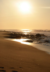 Transition: Sun setting over beach